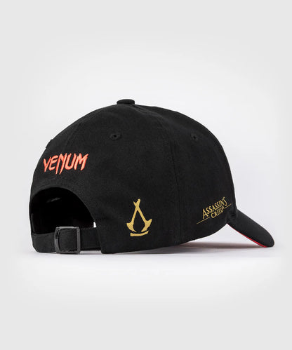 Gorra Venum x Assassin's Creed: Shadows (Negro / Dorado) (Disponible en Costa Rica y por Encargo)